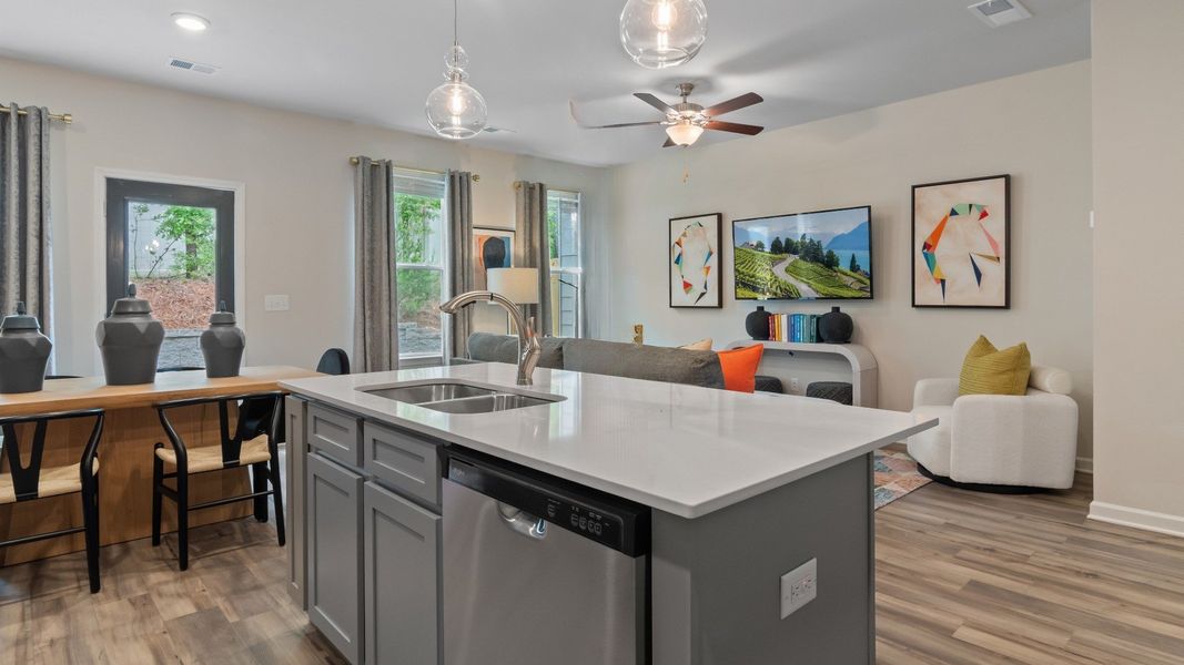 Decorated kitchen island with nearby dining area and gathering room Decorated kitchen island with nearby dining area and gathering room