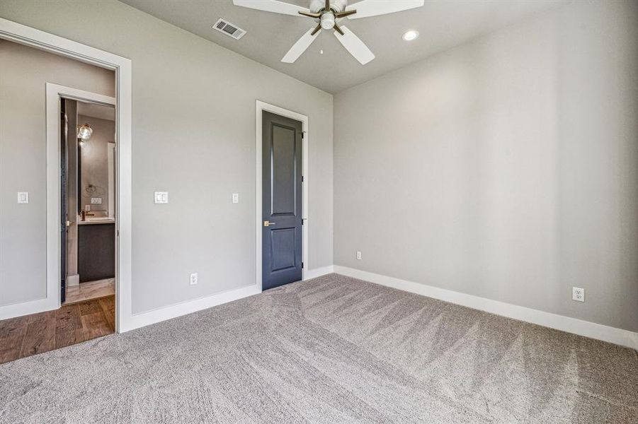 Unfurnished bedroom with carpet flooring and ceiling fan