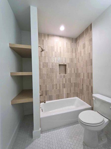 Bathroom with shower / bath combination, light tile patterned floors, and recessed lighting