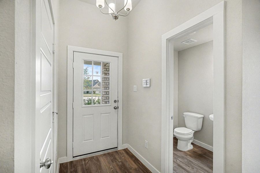 Off the entry is the conveniently located half bathroom and access to the garage. Off the entry is the conveniently located half bathroom and access to the garage.
