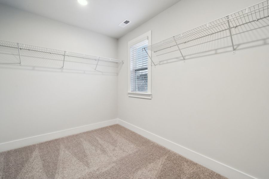 A room with a window and a rug. A room with a window and a rug.