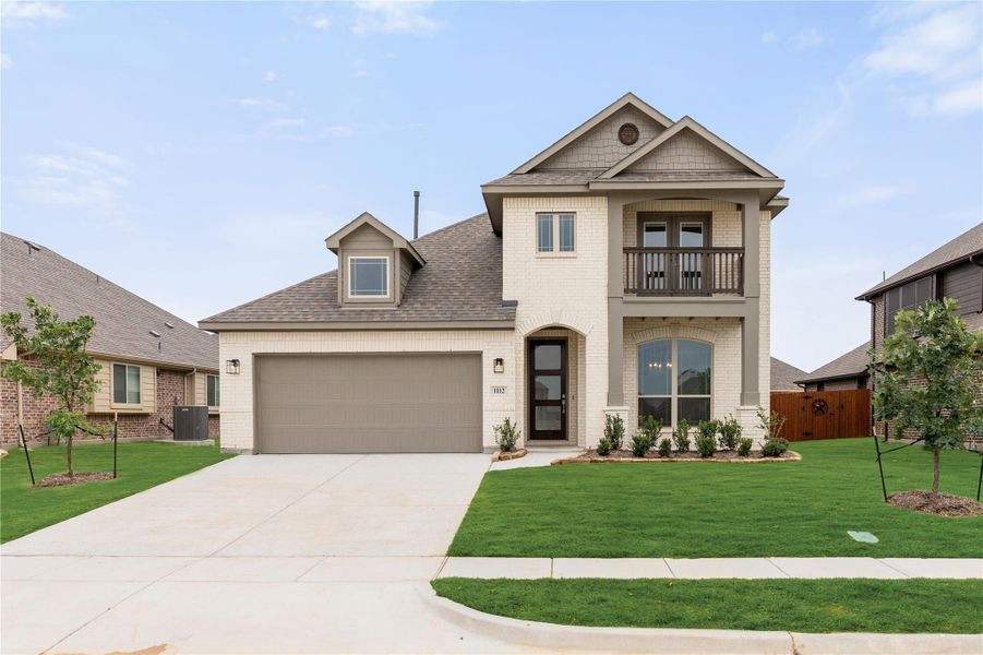 Two-story home with white brick exterior, second-floor balcony, two-car garage, and green front lawn Two-story home with white brick exterior, second-floor balcony, two-car garage, and green front lawn