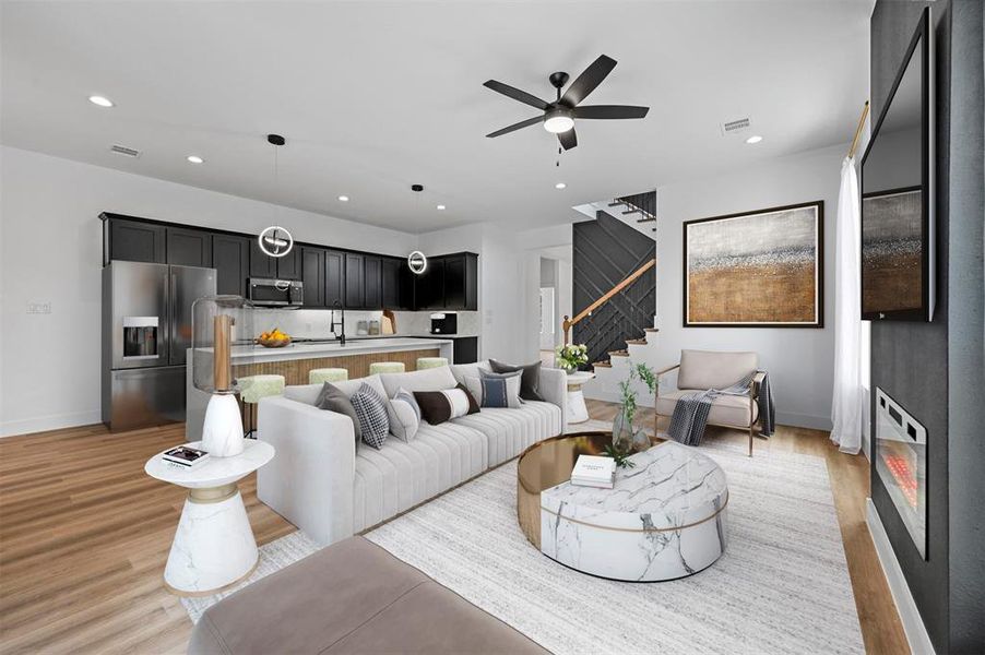 Viturally Staged Living room with light hardwood / wood-style floors and ceiling fan