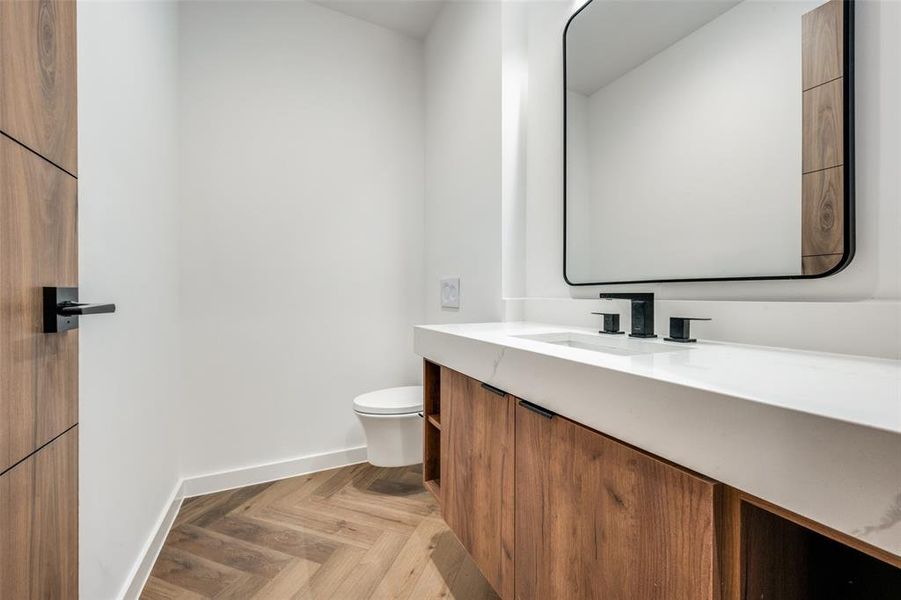 Half bath with toilet and vanity Half bath with toilet and vanity