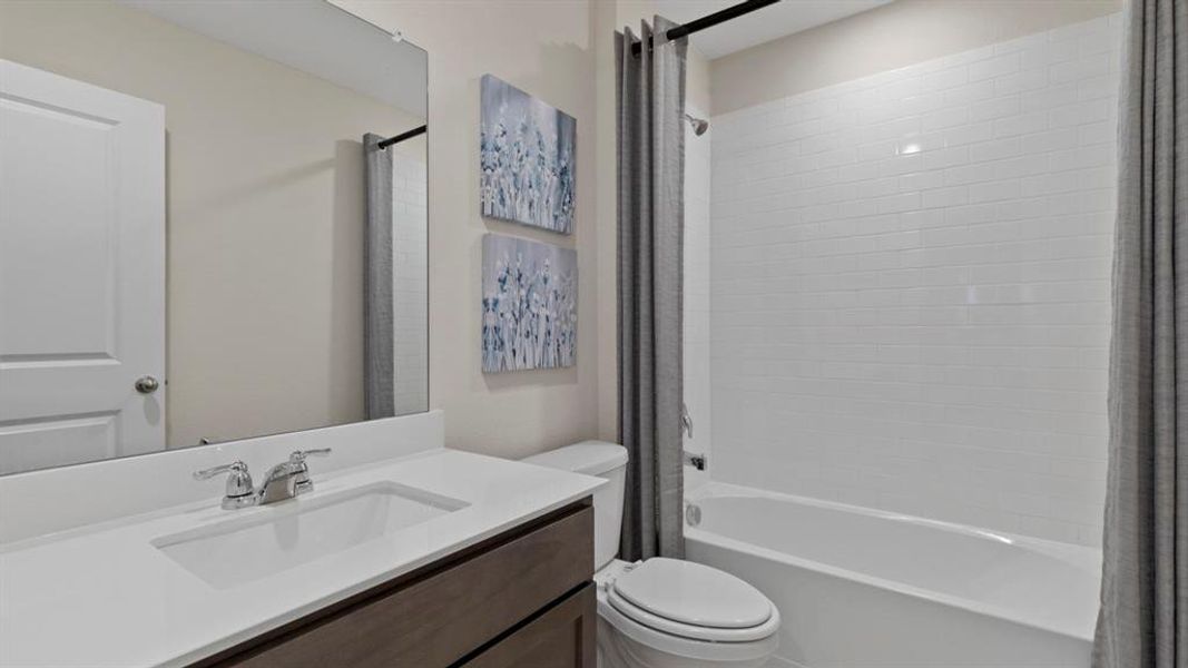 Bathroom featuring vanity and shower / tub combo with curtain