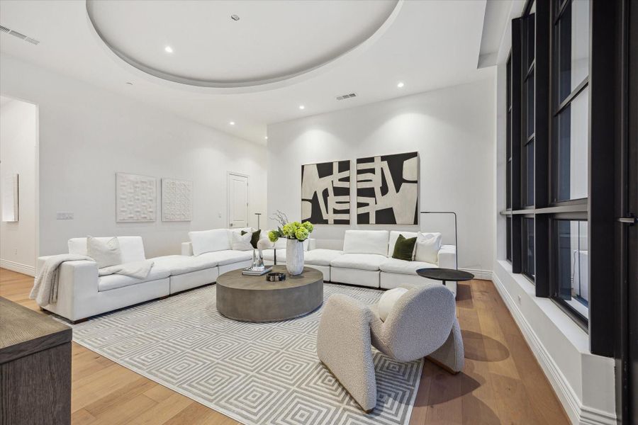 Designed for both comfort and style, this expansive space easily accommodates large-scale furnishings, creating an inviting setting for elegant entertaining or relaxed living. Cove lighting accentuates the architectural details while the 13 foot ceilings create an airy expansive feel. Designed for both comfort and style, this expansive space easily accommodates large-scale furnishings, creating an inviting setting for elegant entertaining or relaxed living. Cove lighting accentuates the architectural details while the 13 foot ceilings create an airy expansive feel.