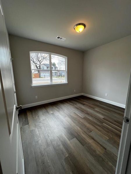 Unfurnished room featuring dark hardwood / wood-style floors