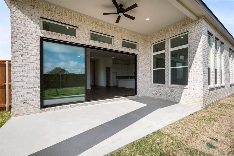 View of patio featuring ceiling fan and plenty of space for grilling or hanging out.