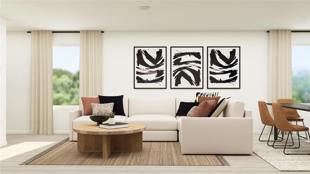 Living room featuring plenty of natural light and light hardwood / wood-style flooring