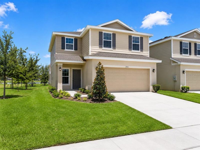 Front exterior of a new home in Harmony Central, St. Cloud, FL, highlighting curb appeal (Image 1). Front exterior of a new home in Harmony Central, St. Cloud, FL, highlighting curb appeal (Image 1).