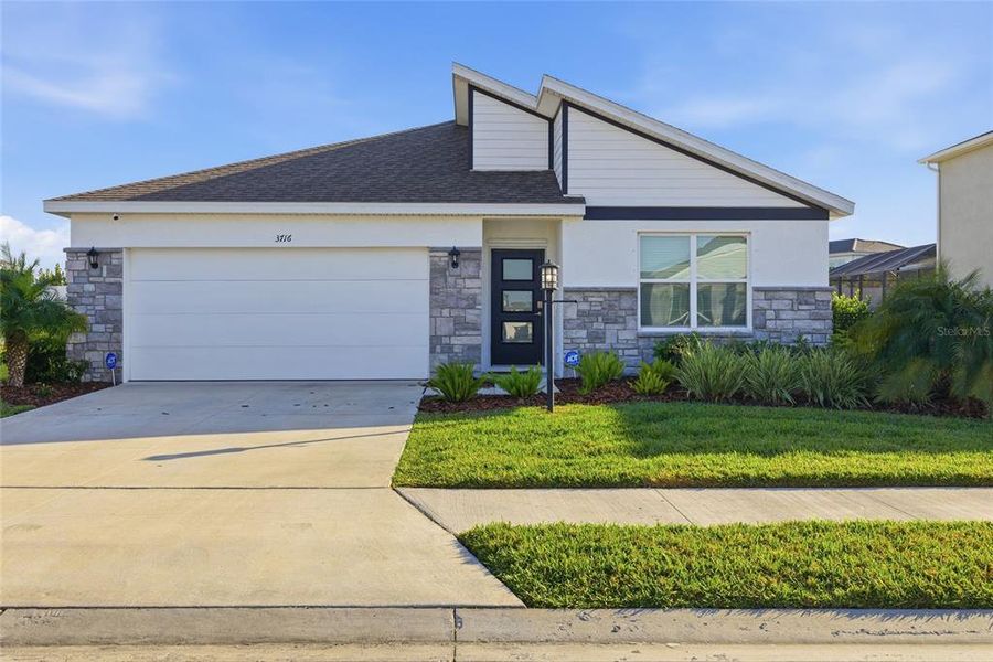 Front exterior of a new home in , Bradenton, FL, highlighting curb appeal (Image 26).