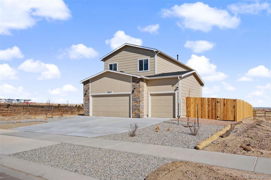 Front exterior of a new home in , Peyton, CO, highlighting curb appeal (Image 28). Front exterior of a new home in , Peyton, CO, highlighting curb appeal (Image 28).