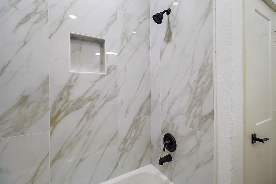 Tiled shower in secondary bathroom