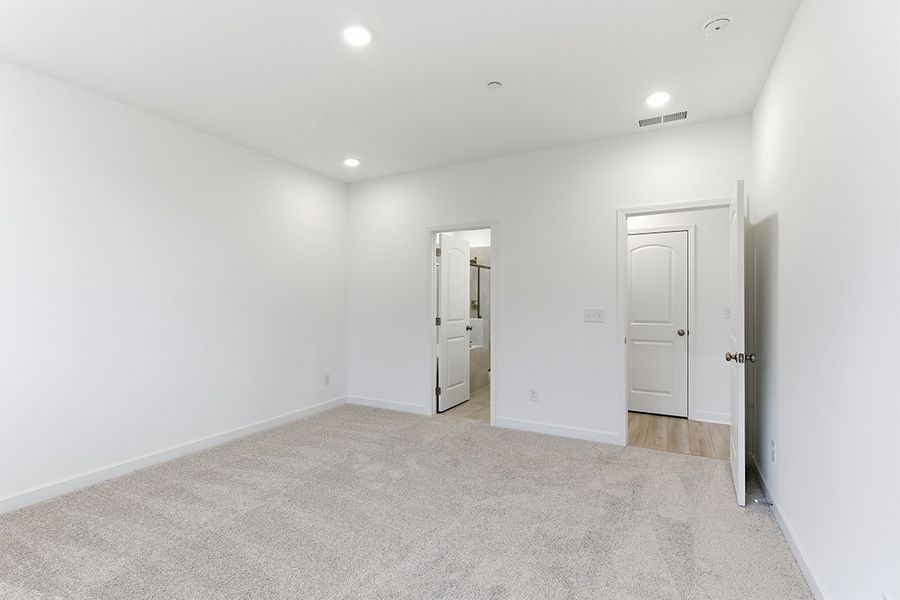 A hallway with white doors.