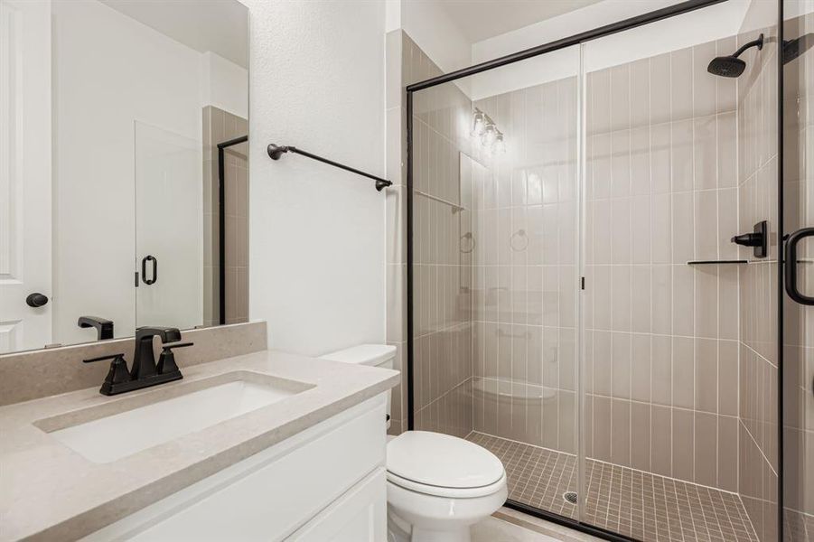 Bathroom with vanity and a shower stall