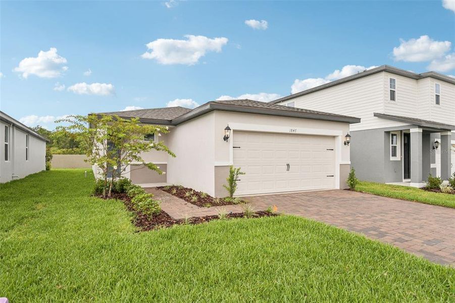 Front exterior of a new home in Two Rivers - Premier Series, Zephyrhills, FL, highlighting curb appeal (Image 19).