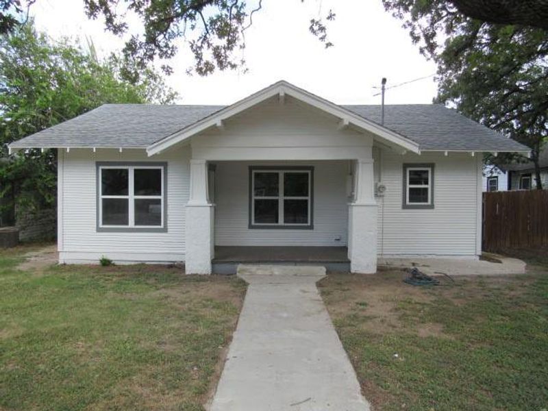 Bungalow with a porch and a shingled roof Bungalow with a porch and a shingled roof