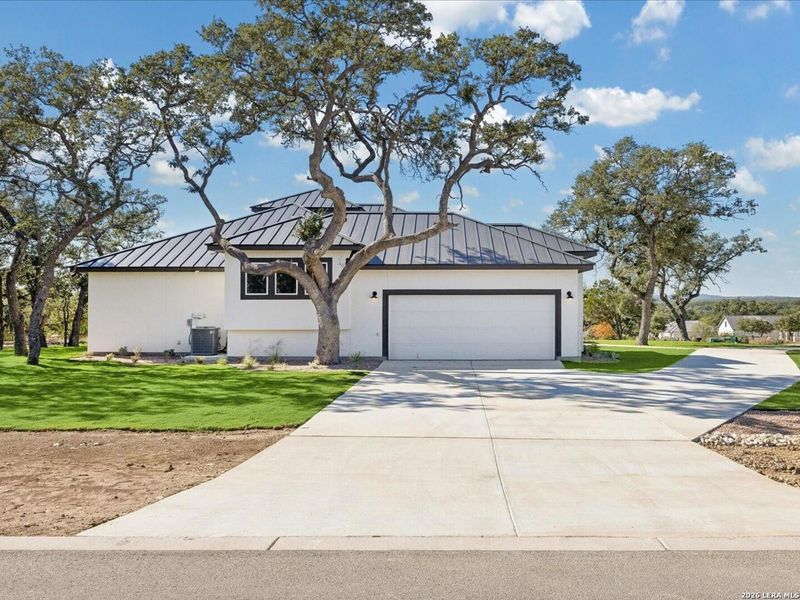 Front exterior of a new home in , Bulverde, TX, highlighting curb appeal (Image 25).