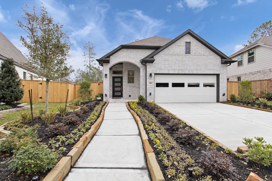 Front exterior of a new home in Wood Leaf Reserve, Tomball, TX, highlighting curb appeal (Image 24). Front exterior of a new home in Wood Leaf Reserve, Tomball, TX, highlighting curb appeal (Image 24).