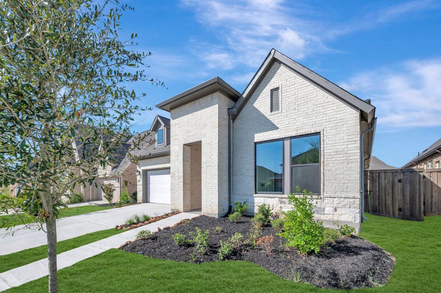 Front exterior of a new home in Riceland - Enclave Collection, Mont Belvieu, TX, highlighting curb appeal (Image 22). Front exterior of a new home in Riceland - Enclave Collection, Mont Belvieu, TX, highlighting curb appeal (Image 22).