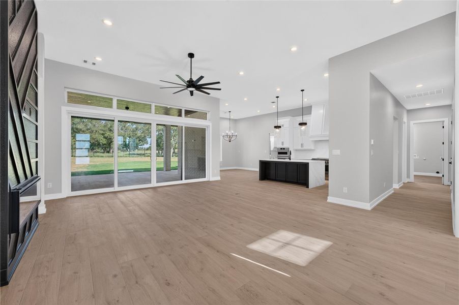 An open floorplan connects the living area to the kitchen, highlighted by sliding glass doors.