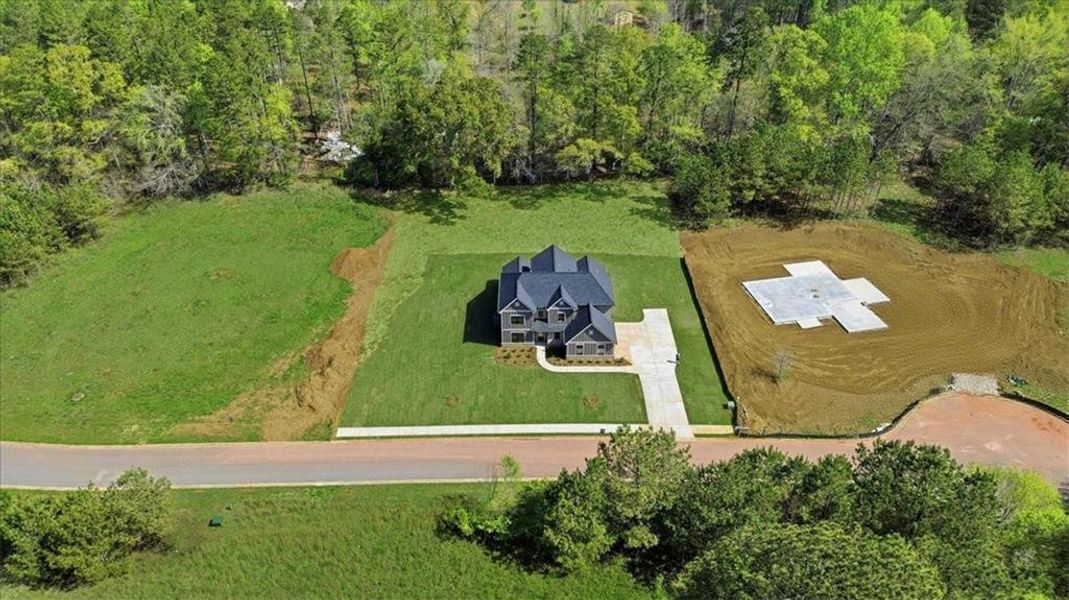 Front exterior of a new home in , Hoschton, GA, highlighting curb appeal (Image 32).