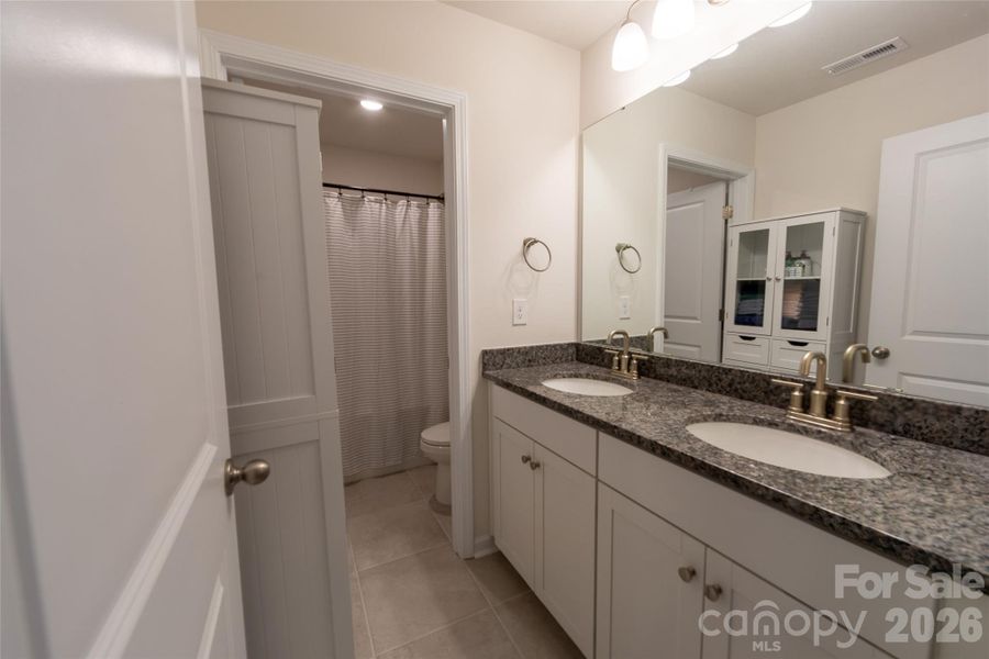 Upper-level full bathroom with tub and shower combo.