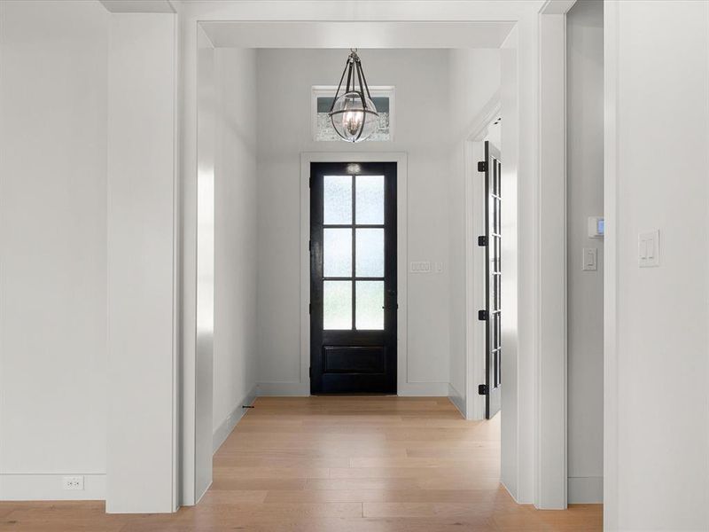 Entrance foyer featuring light wood-style flooring and a chandelier Entrance foyer featuring light wood-style flooring and a chandelier