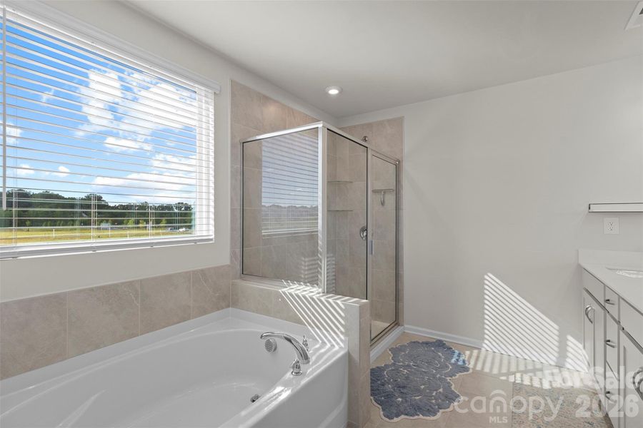 Primary bath featuring large walk-in shower and soaker tub. Primary bath featuring large walk-in shower and soaker tub.