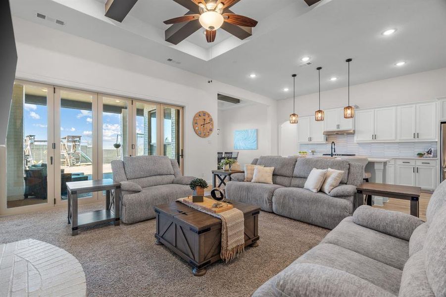 Open concept living room with entertaining doors leading to patio.