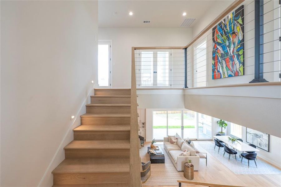 Stairway featuring hardwood / wood-style flooring