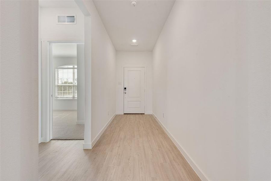 Hall featuring light wood-type flooring