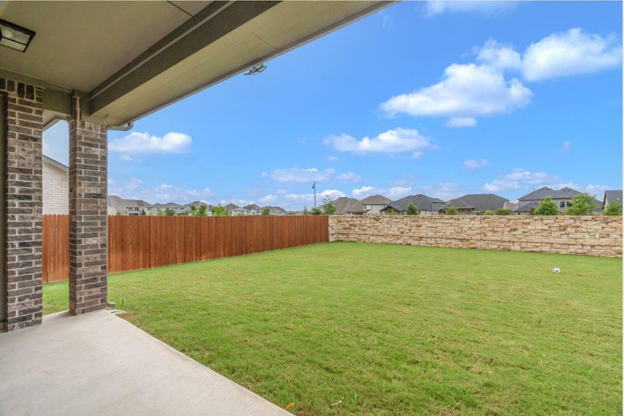A spacious backyard with a private patio and mature landscaping, perfect for outdoor entertaining.