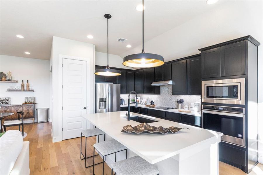 Enjoy gorgeous designer details throughout this home! From the wall treatments to the light fixtures and wood flooring throughout.