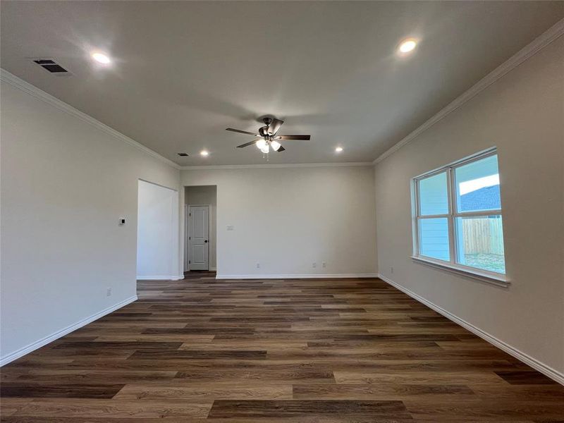 Living Room with Crown Molding and Luxury Vinyl Plank Floors