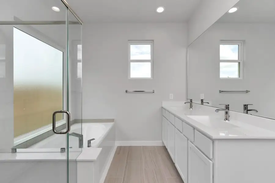 Immerse yourself in a luxurious retreat within the confines of your main bathroom. Sample photo of completed home with similar floor plan. Actual colors and selections may vary.