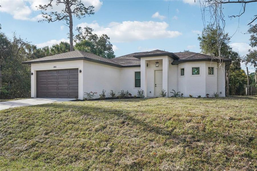 Front exterior of a new home in , North Port, FL, highlighting curb appeal (Image 24).