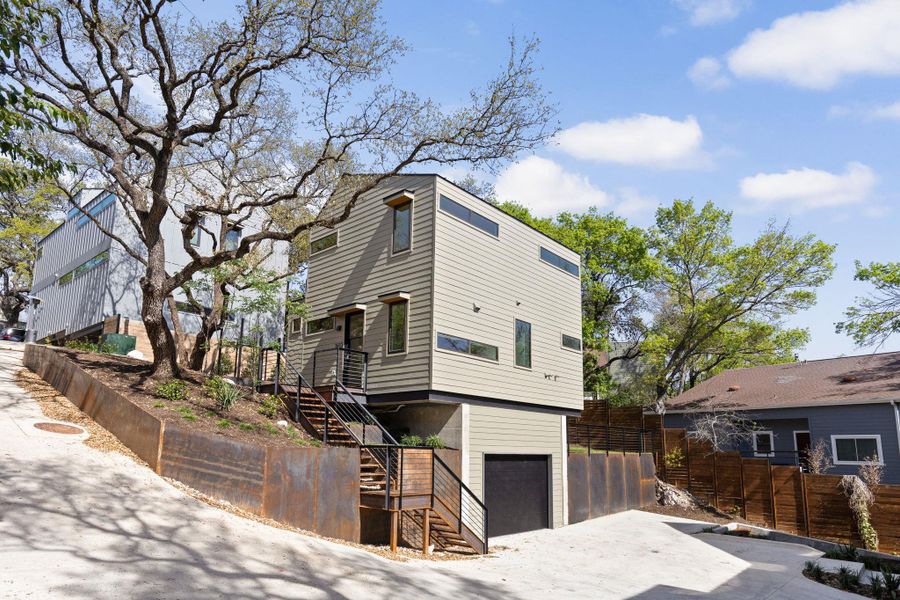 View of front of home with an attached garage and driveway