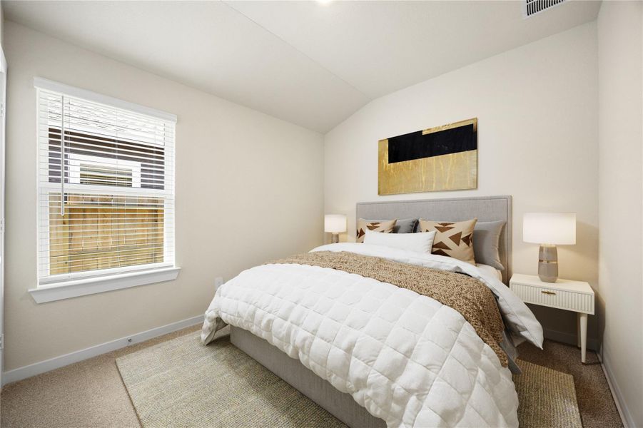 This inviting secondary bedroom offers soft natural light, neutral tones, and plush carpeting, creating a warm and comfortable space ideal for guests, children, or a home office.