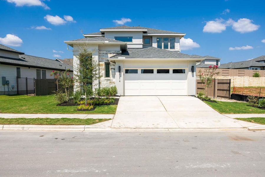 Prairie-style house featuring concrete driveway, a shingled roof, a garage, and stone siding Prairie-style house featuring concrete driveway, a shingled roof, a garage, and stone siding
