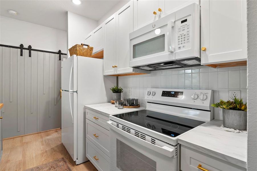 Kitchen with white cabinetry.