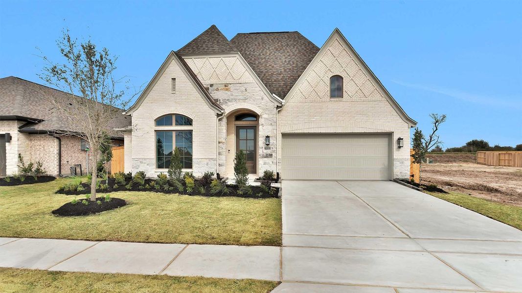 Front exterior of a new home in Meridiana, Manvel, TX, highlighting curb appeal (Image 2). Front exterior of a new home in Meridiana, Manvel, TX, highlighting curb appeal (Image 2).