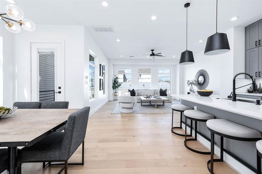 Shot from the top of the stairs. Large living area straight ahead, kitchen on the right and dining on the left.