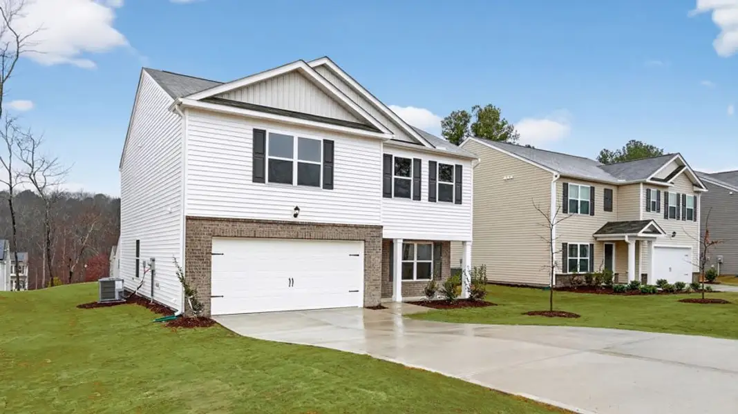 Front exterior of a new home in Mangum Farms, Stem, NC, highlighting curb appeal (Image 2). Front exterior of a new home in Mangum Farms, Stem, NC, highlighting curb appeal (Image 2).