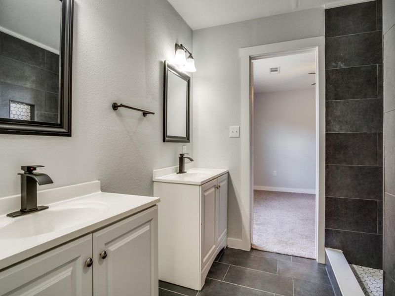 Bathroom featuring dual bowl vanity and tile patterned floors Bathroom featuring dual bowl vanity and tile patterned floors