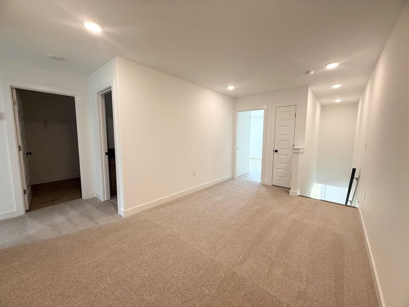 Spare room featuring light carpet, recessed lighting, and a smoke detector