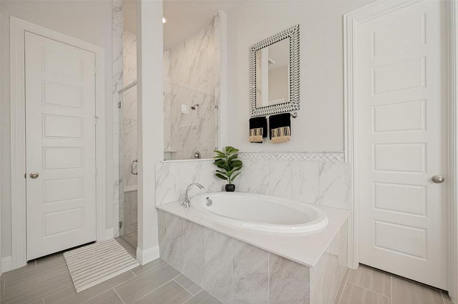 This elegant primary bathroom offers a spacious layout designed for both relaxation and convenience. Enjoy a large soaking tub framed by beautiful tile surround, the perfect place to unwind after a long day. The bright, neutral finishes, decorative niche, and thoughtful design create a spa-like atmosphere, while the adjacent dual-vanity area and generous storage make everyday living effortless. This elegant primary bathroom offers a spacious layout designed for both relaxation and convenience. Enjoy a large soaking tub framed by beautiful tile surround, the perfect place to unwind after a long day. The bright, neutral finishes, decorative niche, and thoughtful design create a spa-like atmosphere, while the adjacent dual-vanity area and generous storage make everyday living effortless.