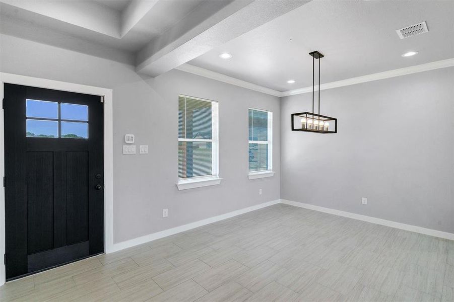 Entrance foyer with plenty of natural light and crown molding