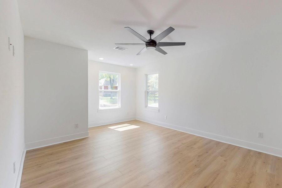 Spare room with light wood-type flooring, a ceiling fan, and recessed lighting