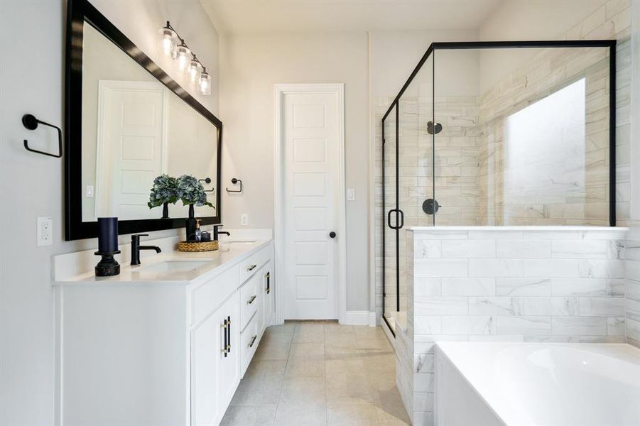 Full bath with double vanity, a shower stall, and a garden tub Full bath with double vanity, a shower stall, and a garden tub